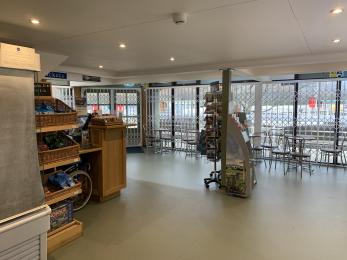 Inside the Glenridding Pier House, showing the ticket desk and indoor seating areas.