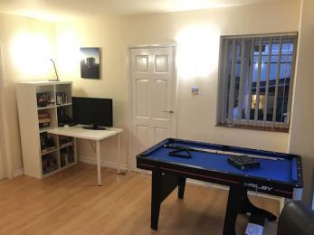Pool table, TV and games selection in 4th bedroom