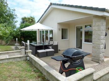 Rear patio with gas barbecue and patio table with 6 chairs and 4 stools