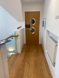 Image shows fire door into Research Studio. Stairway onto ground floor can be seen on the right. 