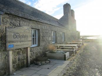 Photo shows 3 picnic benches situated directly outside the visitor centre 