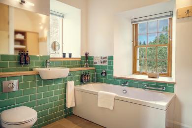 Slackbrae green bathroom: WC, sink, bath, handrail, showerstick, two windows, cupboards