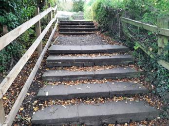 Steps leading up to mill pond if going left from children's play area 