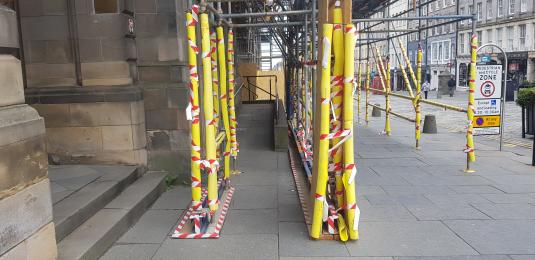 Temporary scaffolding leading to main entrance/ramp