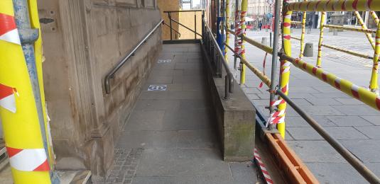 Temporary scaffolding leading to ramp