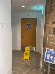 Image shows corridor to toilets. Disabled toilet door is can be seen from here 