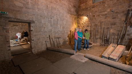 Photo showing mats over cobbled flooring and low lighting in the Icehouse. 
