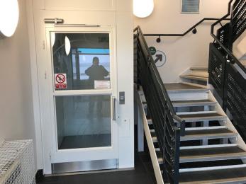 Visitor Hub lift next to stairway