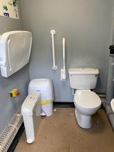 Accessible toilet with transfer space and handles