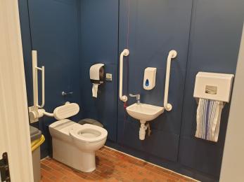Standard accessible toilet with baby change facility.