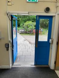 Back door with push button to open, leading from visitor centre to the garden and reserve