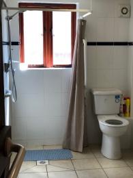 The is a spacious shower/wet room with a disabled toilet and accessible features.