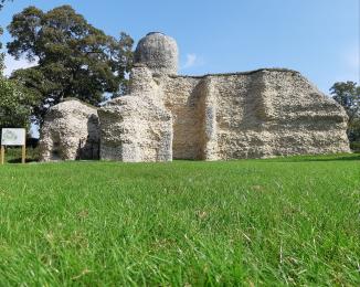Image of Walden Castle ruins, with grass to the front and a blue sky. 
