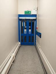 Corridor to door leading to area where lift is situated. 