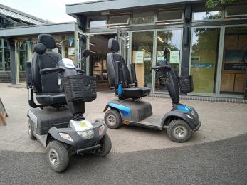 Two mobility scooters that are available for hire 