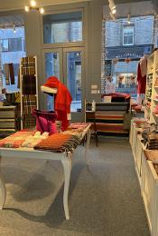 Scottish Textiles Showcase Edinburgh shop interior showing floor space between wall and table.