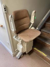 Stannah stair lift at bottom of stairs to cafe ready to use