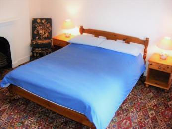 Double bed with blue bed linen