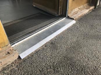 Small ramped door threshold at entrance to cafe