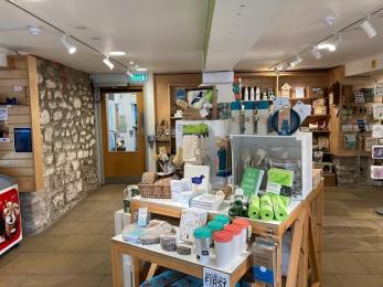Visitor centre shop products and door through to toilets and reserve