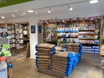 Visitor centre shop with access for wheelchair showing seed sack display