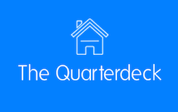 The Quarterdeck logo, a white house on a blue background