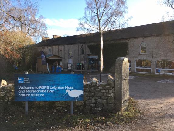 Leighton Moss visitor centre showing welcome sign and entrance to disabled car park
