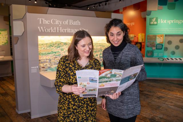 Image: Visitors looking at a map in the Bath World Heritage Centre
